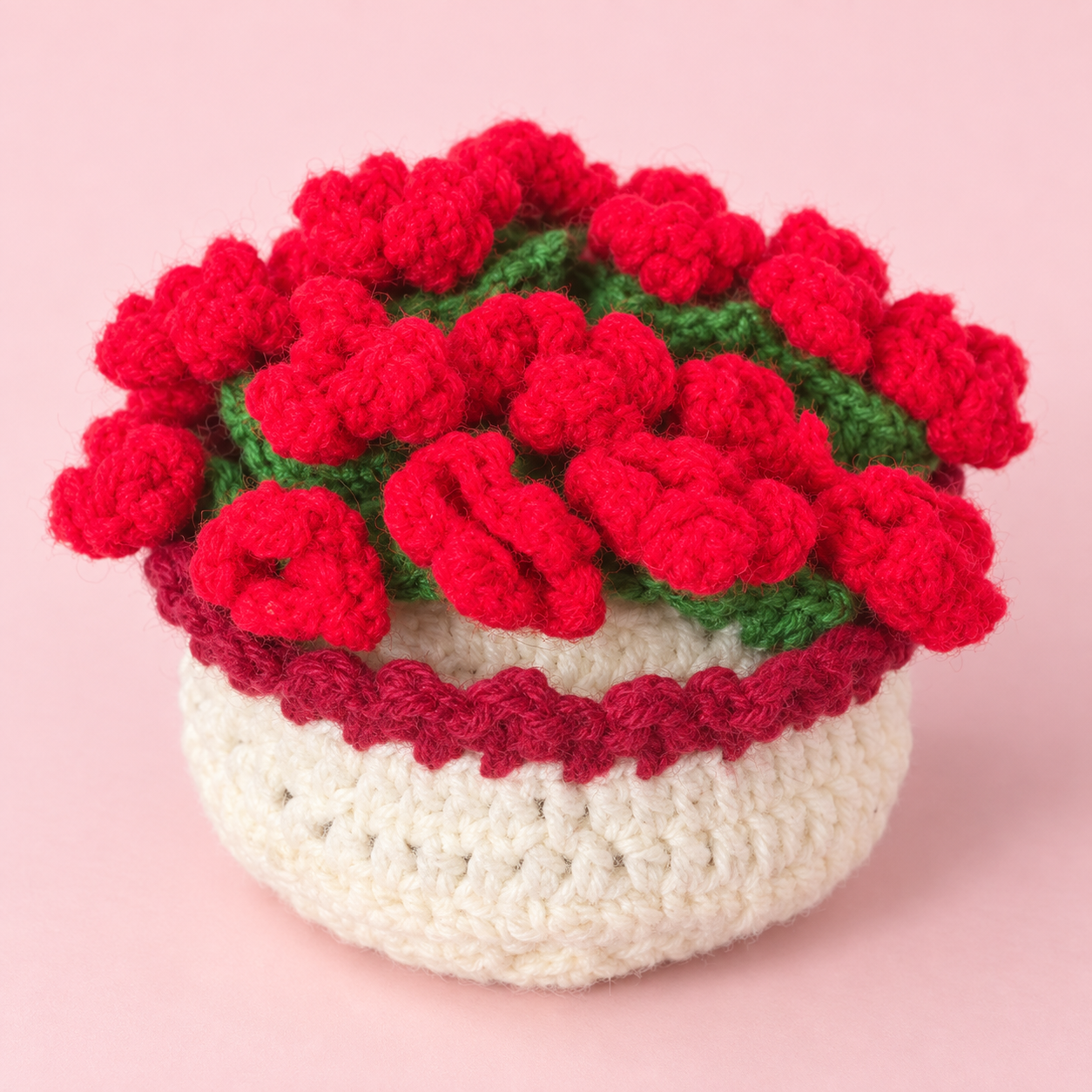 Red crochet flowers gathered above a cream crochet base